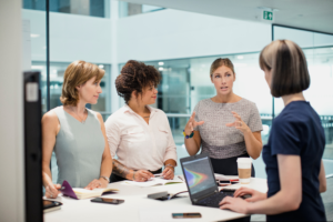 4 businesswomen working in an office space