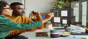 workers pointing at computer